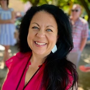 Rebecca Blackwell wearing a red shirt and smiling at the camera