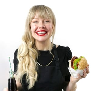 Sam Turnbull, smiling and holding a veggie burger